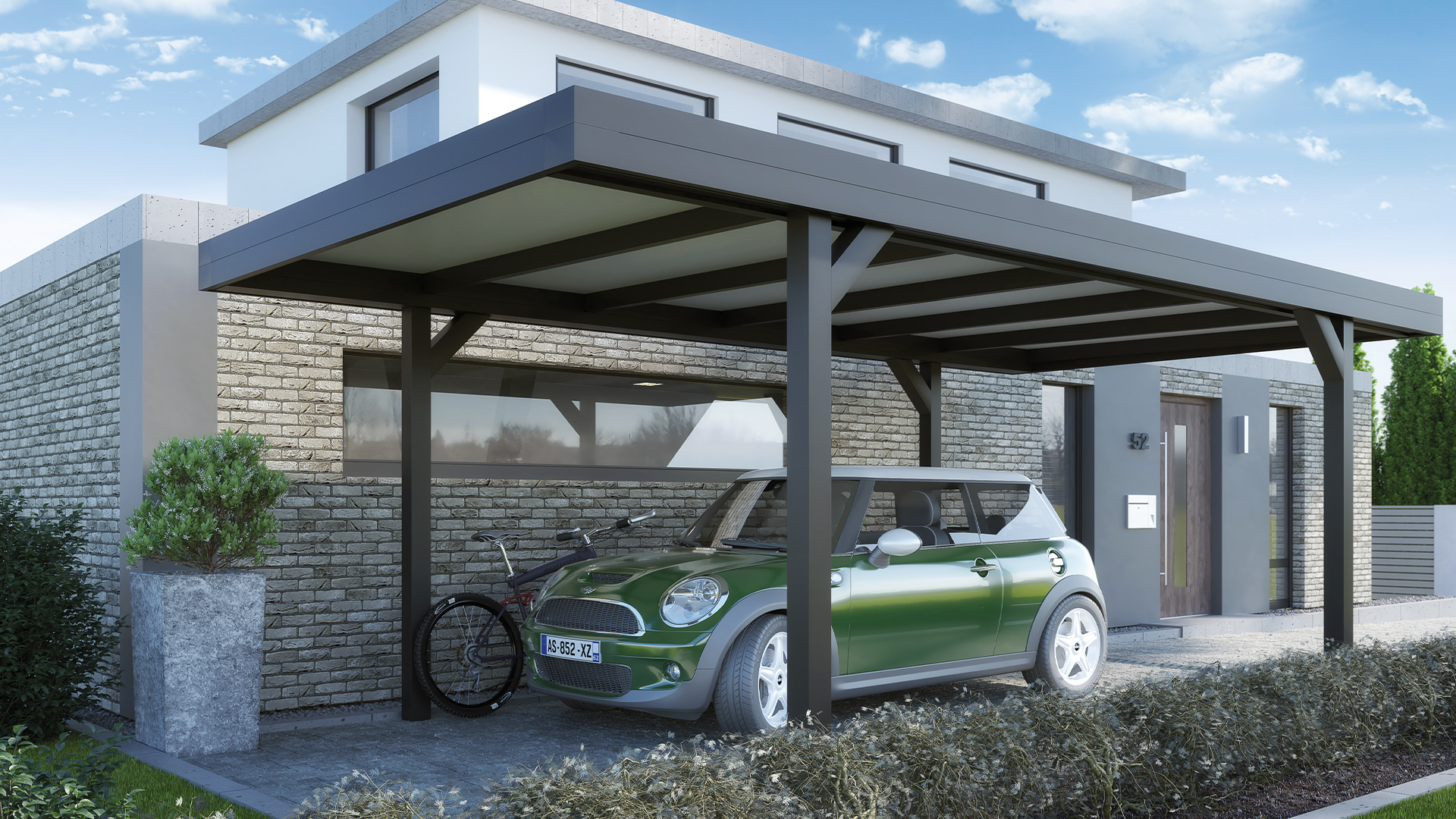 Ein grünes Auto und ein Fahrrad unter einem modernen Carport vor einem Backsteinhaus.